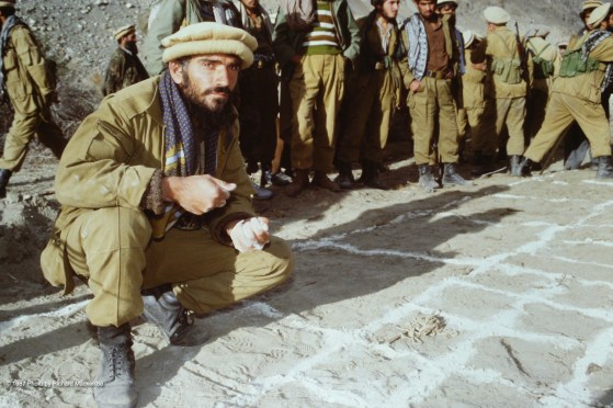 The intricate details of a sand table outlining battle plans begin with a large grid drawn in the dirt.