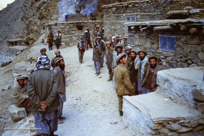 Mujahideen gather as they wait in the shadow of a karaghah in the Panjshir Valley.